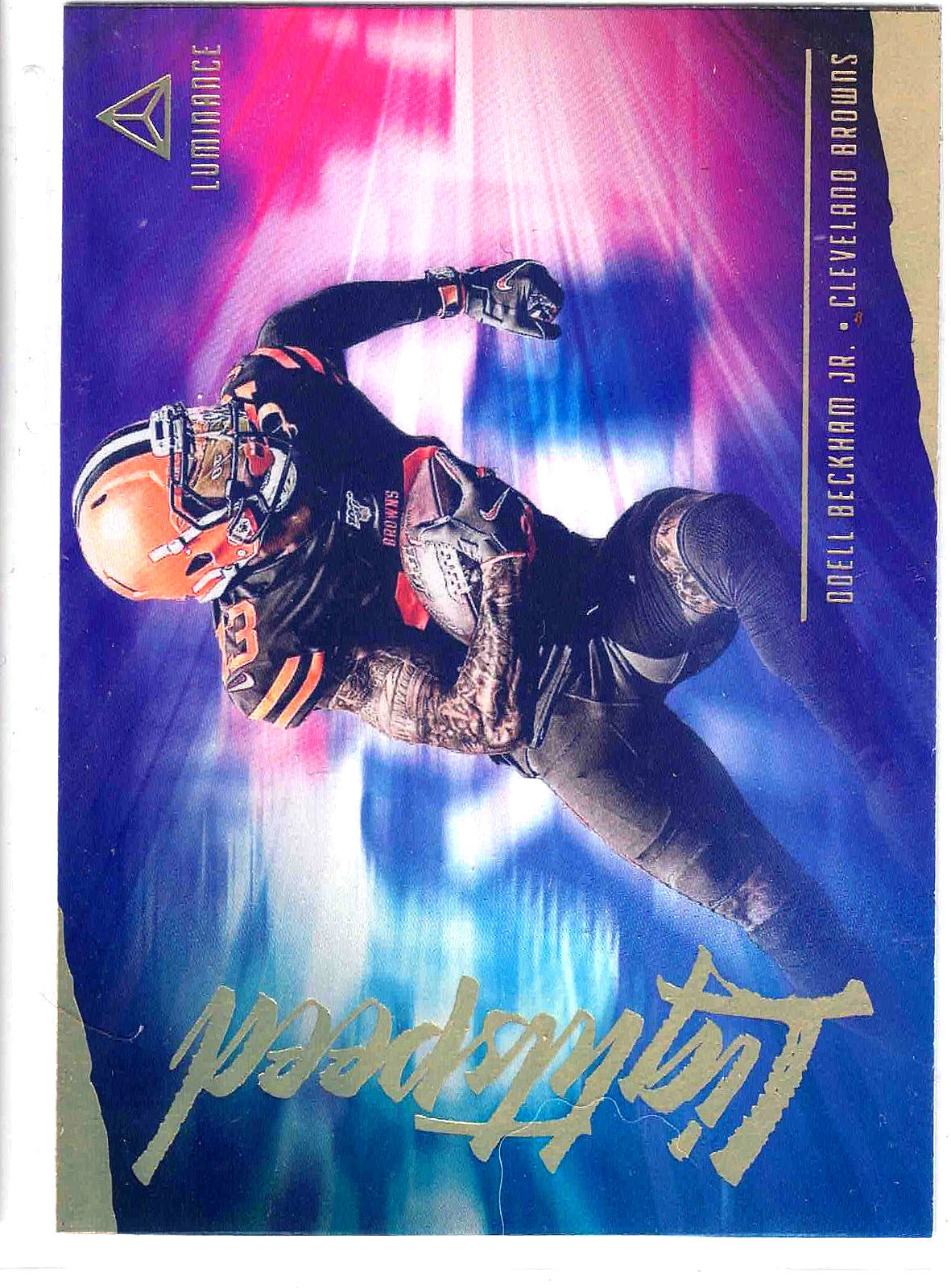 A collectible football trading card featuring Drell Beckham Jr. of the Cleveland Browns in action, with a vibrant blue, purple, and pink background and metallic gold accents.