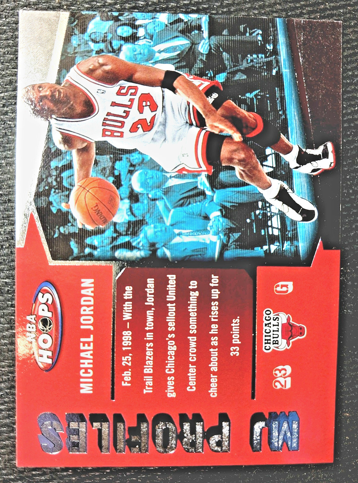 A vintage 1998 NBA Hoops Michael Jordan trading card featuring a red left panel with player text and a photo of Jordan in a Chicago Bulls jersey on the right.